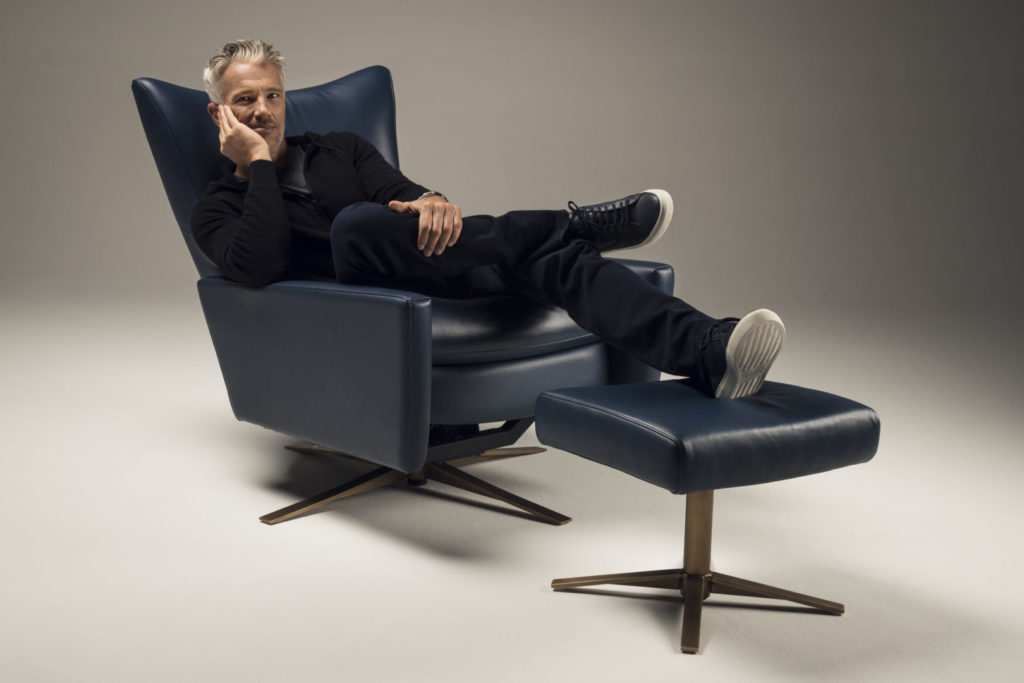 Man reclined in a Comfort Air Stratus Chair with Ottoman
